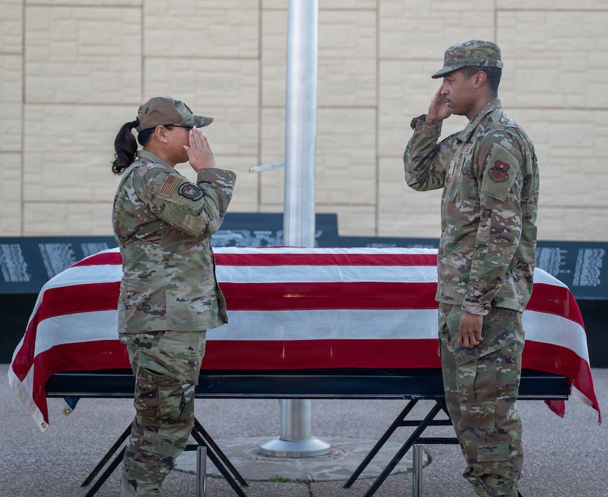 U.S. Air Force Lt. Col. Maria Berardo (left), 56th Force Support Squadron commander, returns a salute to Airman Cameron Hough (right), 56th Fighter Wing honor guardsman, during a coin presentation for outstanding service at a ceremony, Dec. 2, 2025, at Luke Air Force Base, Arizona.