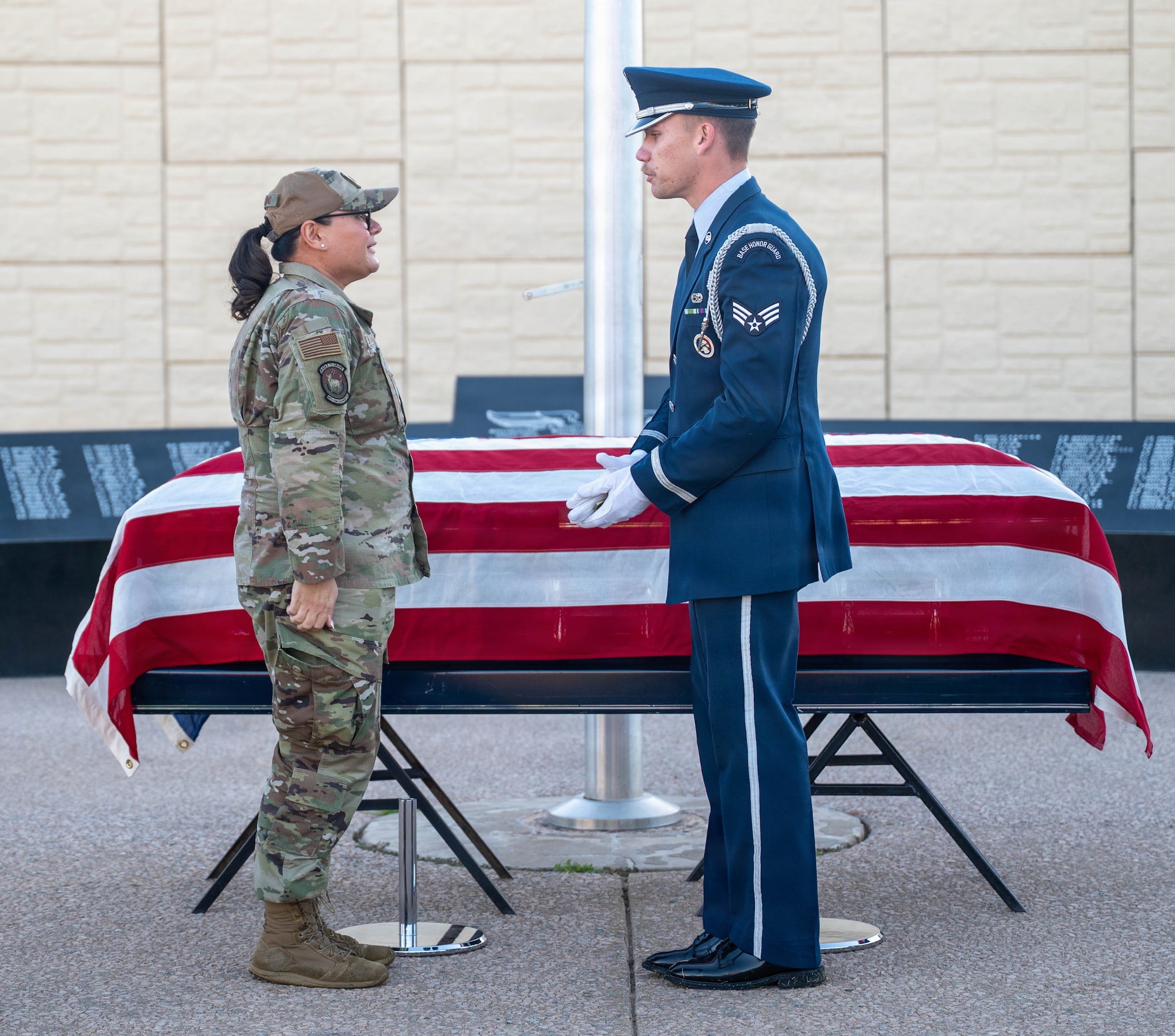 U.S. Air Force Lt. Col. Maria Berardo (left), 56th Force Support Squadron commander, presents a challenge coin from the Vice Chief of Staff of the Air Force to Senior Airman Matthew Mangeson (right), 56th Fighter Wing honor guardsman during a ceremony, Dec. 2, 2025, at Luke Air Force Base, Arizona.