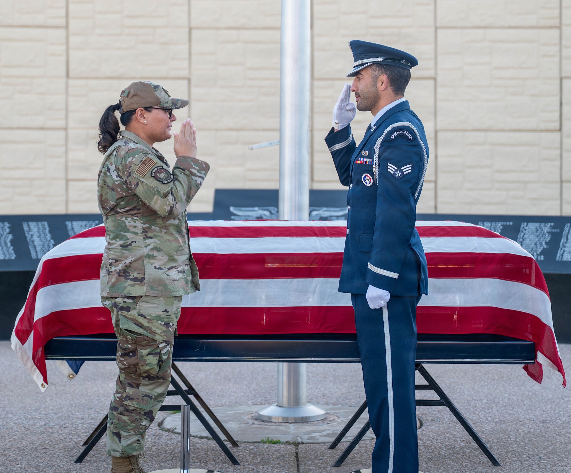 U.S. Air Force Lt. Col. Maria Berardo (left), 56th Force Support Squadron commander, and Senior Airman Elias Kokalis (right), 56th Fighter Wing honor guardsman, returns a salute during a coin presentation, Dec. 2, 2025, at Luke Air Force Base, Arizona.