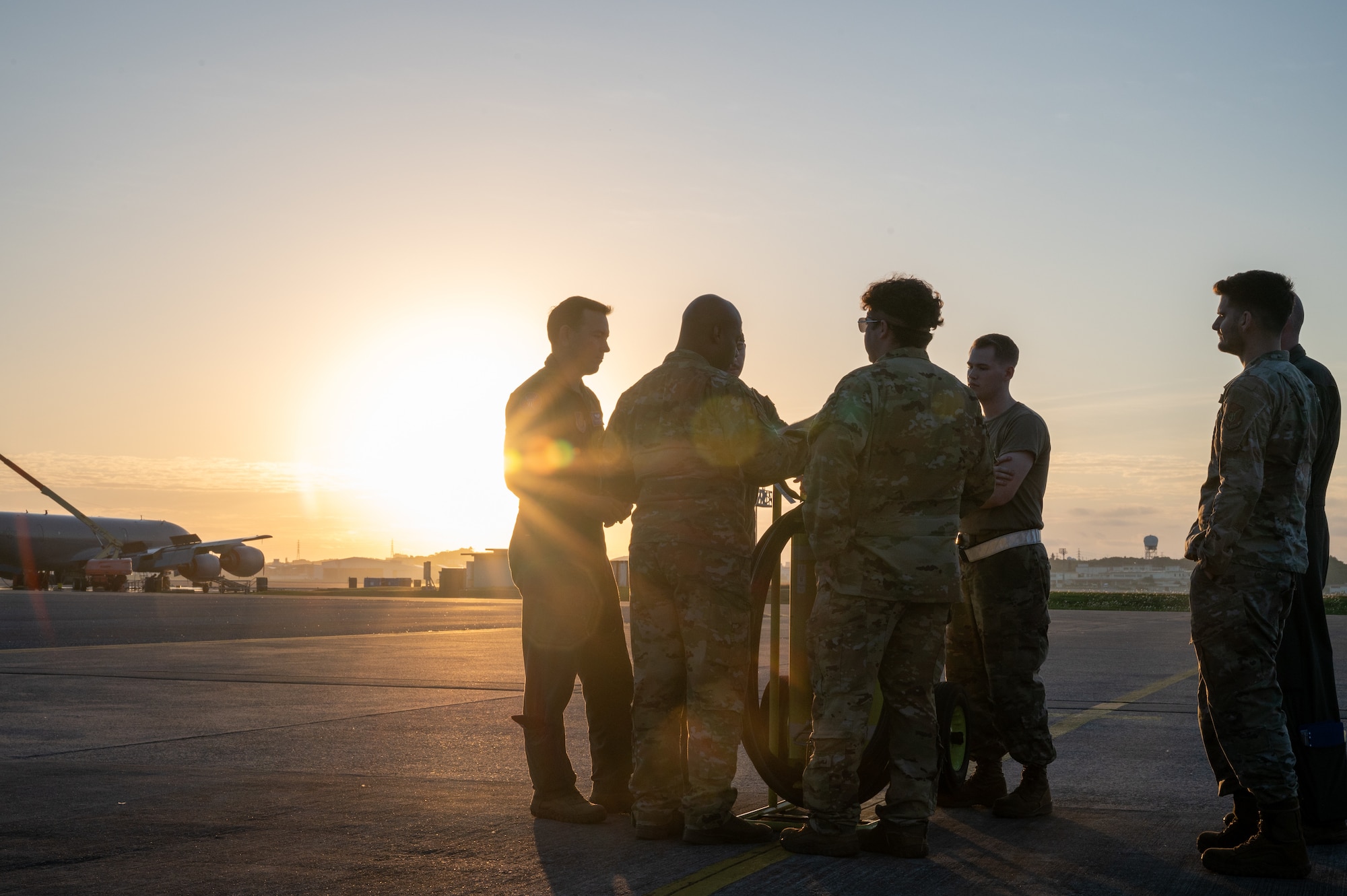 Service members conduct a preflight brief on the flightline.
