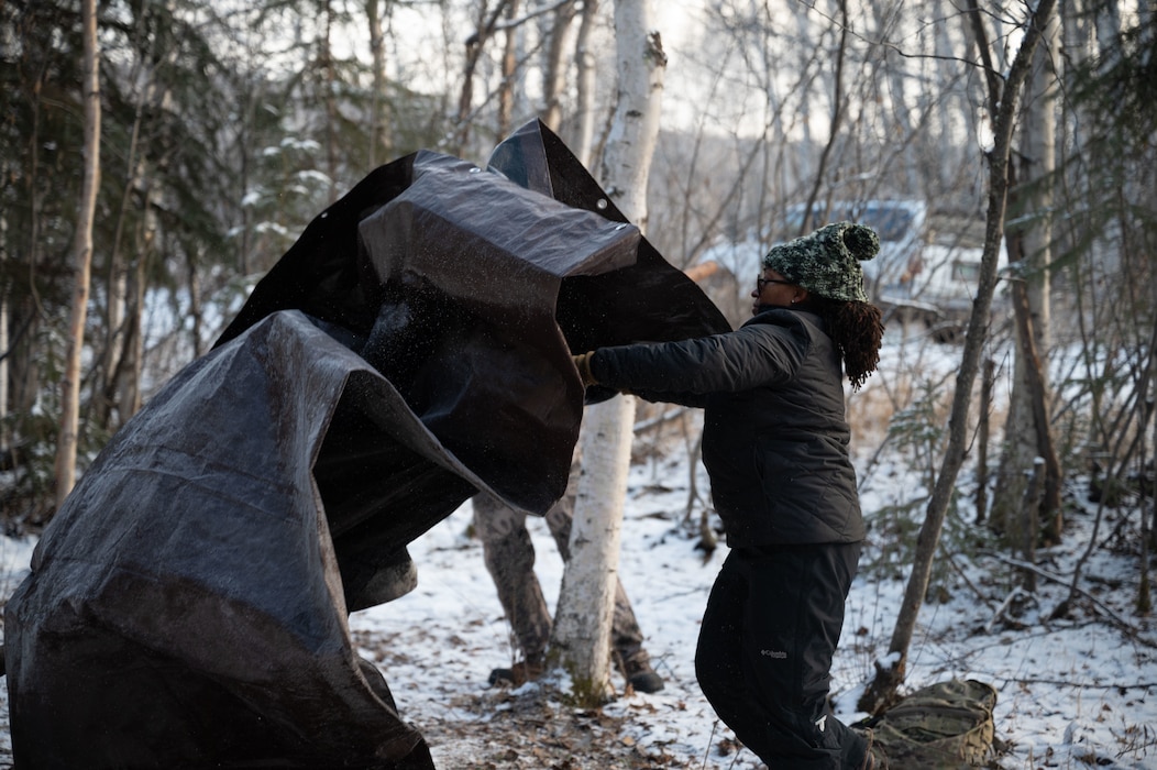 U.S. Air Force Chief Master Sgt. Cheronica Blandburg, 354th Fighter Wing command chief, sets up a shelter during Arctic Resiliency Training at Eielson Air Force Base, Alaska, Oct. 29, 2025.