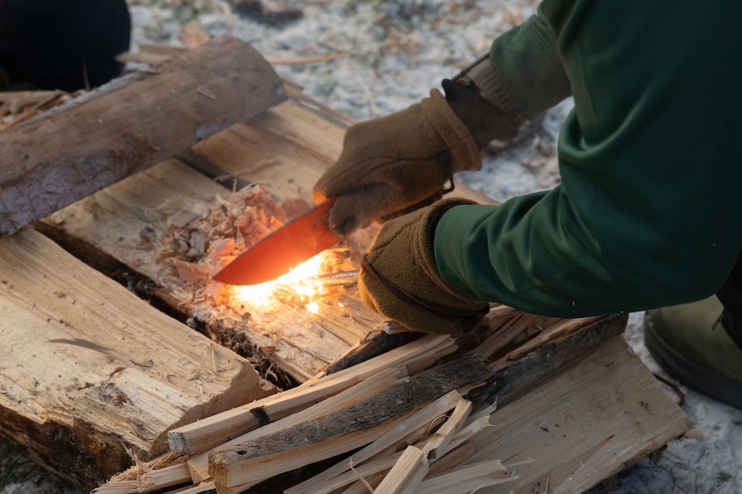 U.S. Air Force Chief Master Sgt. Matthew Perry, 354th Maintenance Group senior enlisted leader, starts a fire during Arctic Resiliency Training at Eielson Air Force Base, Alaska, October 29, 2025.