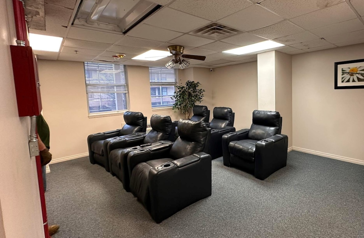 six black recliners sit in a room