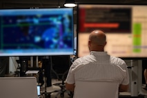 backview of a person working on computers