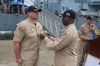 Capt. Kelechi Ndukwe, commodore of Destroyer Squadron (DESRON) 60, awards Cmdr. Joseph Phillips, commanding officer of the USS Paul Ignatius (DDG 117), with a Meritorious Service Medal during a change of command ceremony onboard Naval Station Rota, Spain, on January 1, 2026.