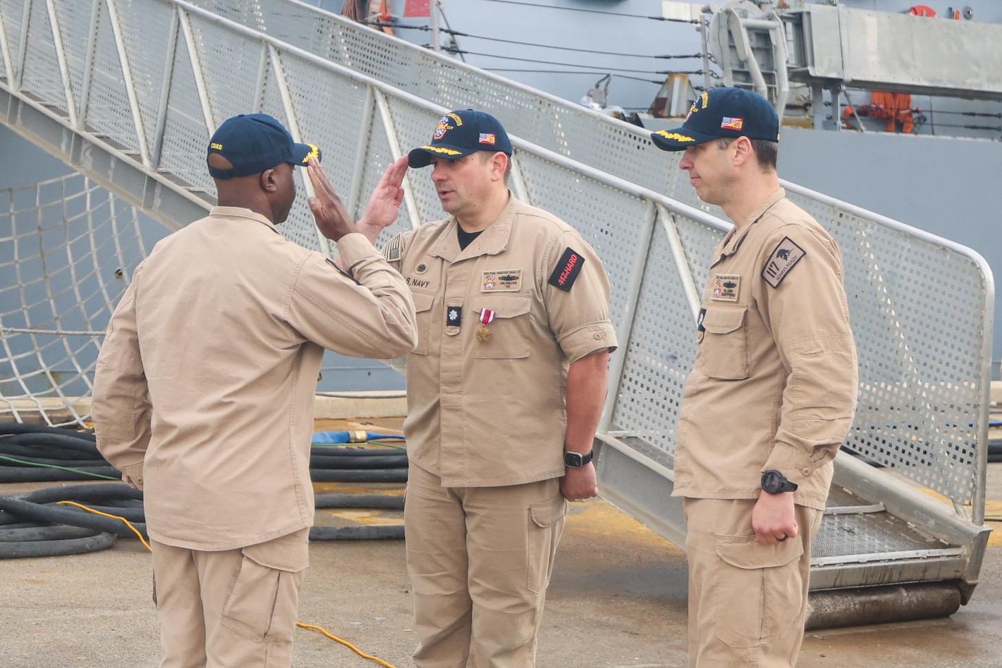 During a change of command ceremony at Naval Station Rota, Spain, Capt. Kelechi Ndukwe, commodore of Destroyer Squadron 60, salutes Cmdr. Joseph Phillips as he is relieved of duty on January 1, 2026.