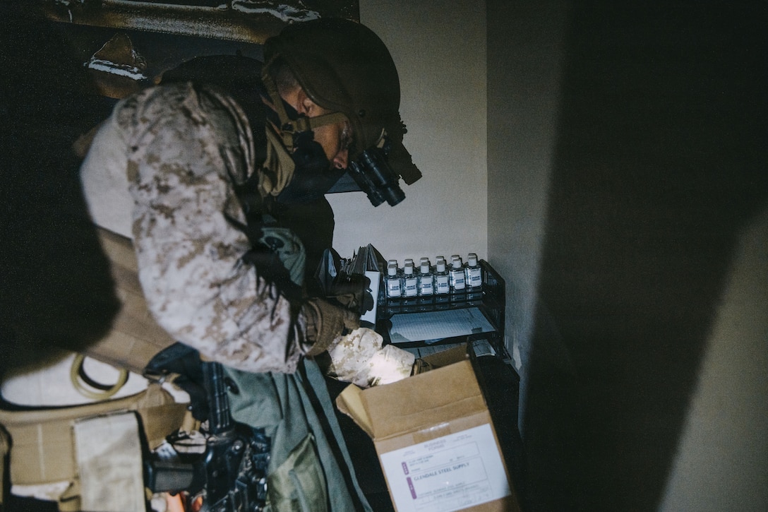 A U.S. Marine with the Maritime Raid Force, 11th Marine Expeditionary Unit, searches for exploitable material during a night raid as part of Realistic Urban Training in Glendale, Arizona, Nov. 10, 2025. RUT is a land-based training exercise that enables the 11th MEU to conduct expeditionary operations as a cohesive Marine Air-Ground Task Force in preparation for amphibious operations alongside the U.S. Navy. (U.S. Marine Corps photo by Sgt. Joseph Helms)