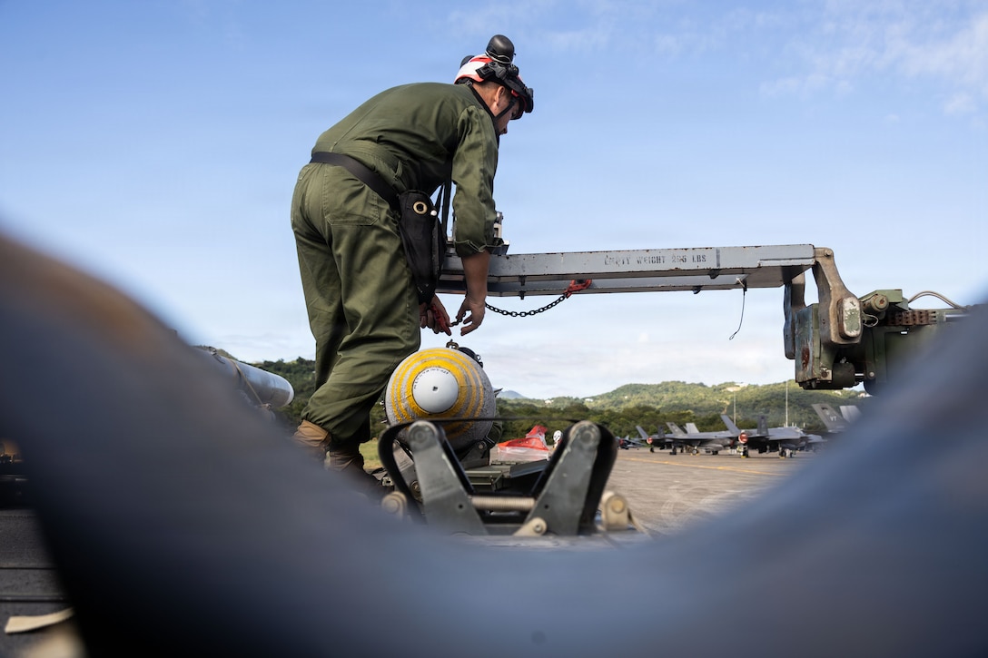 A U.S. Marine Corps ordnance technician with Marine Fighter Attack Squadron (VMFA) 225, U.S. Marine Corps Forces, South, attaches a Laser Joint Directed Attack Munition to a Short Airfield for Tactical Support weapons loader at Jose Aponte de la Torre Airport in Ceiba, Puerto Rico, Dec. 22, 2025. U.S. military forces are deployed to the Caribbean in support of the U.S. Southern Command mission, Department of War-directed operations, and the president’s priorities to disrupt illicit drug trafficking and protect the homeland. (U.S. Marine Corps photo)