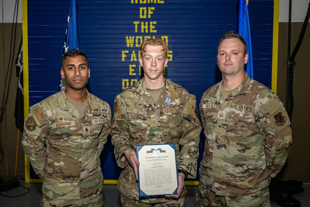 U.S. Air Force Airman 1st Class Ryland Perez-Settle, 822nd Base Defense Squadron poses with 822nd BDS leadership following the presentation of the Air Force Achievement Medal.
