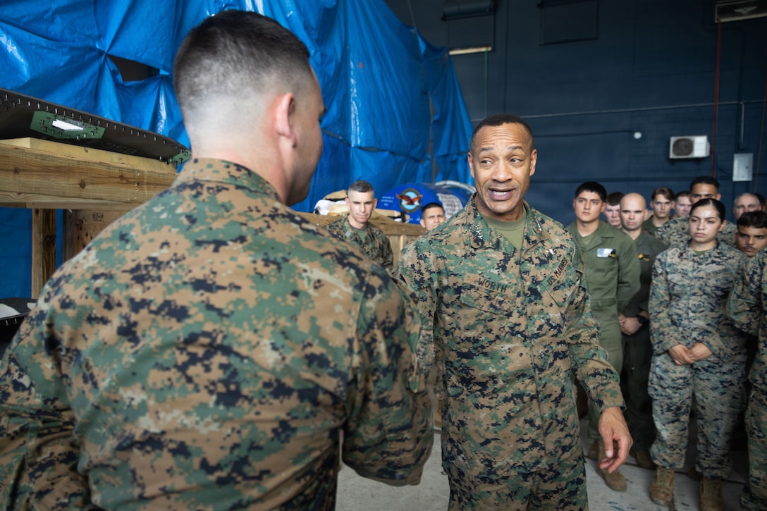U.S. Marine Corps Lt. Gen. Calvert L. Worth, right, commanding general, II Marine Expeditionary Force, presents a challenge coin to a U.S. Marine with Joint Communications Support Element, U.S. Transportation Command, at Jose Aponte de la Torre Airport in Ceiba, Puerto Rico, Dec. 12, 2025. U.S. military forces are deployed to the Caribbean in support of the U.S. Southern Command mission, Department of War-directed operations, and the president’s priorities to disrupt illicit drug trafficking and protect the homeland. (U.S. Marine Corps photo)