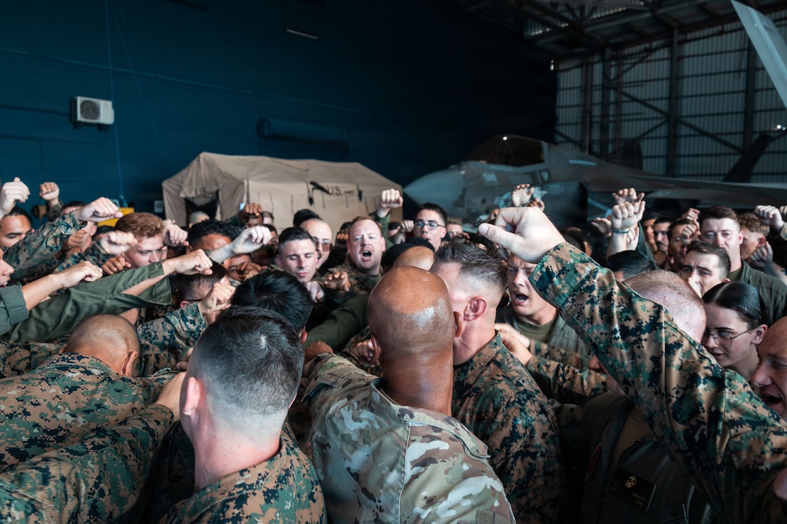U.S. service members with Marine Fighter Attack Squadron (VMFA), 225, U.S. Marine Corps Forces, South, and Joint Communications Support Element, U.S. Transportation Command, perform a unit chant at Jose Aponte de la Torre Airport in Ceiba, Puerto Rico, Dec. 12, 2025. U.S. military forces are deployed to the Caribbean in support of the U.S. Southern Command mission, Department of War-directed operations, and the president’s priorities to disrupt illicit drug trafficking and protect the homeland. (U.S. Marine Corps photo)