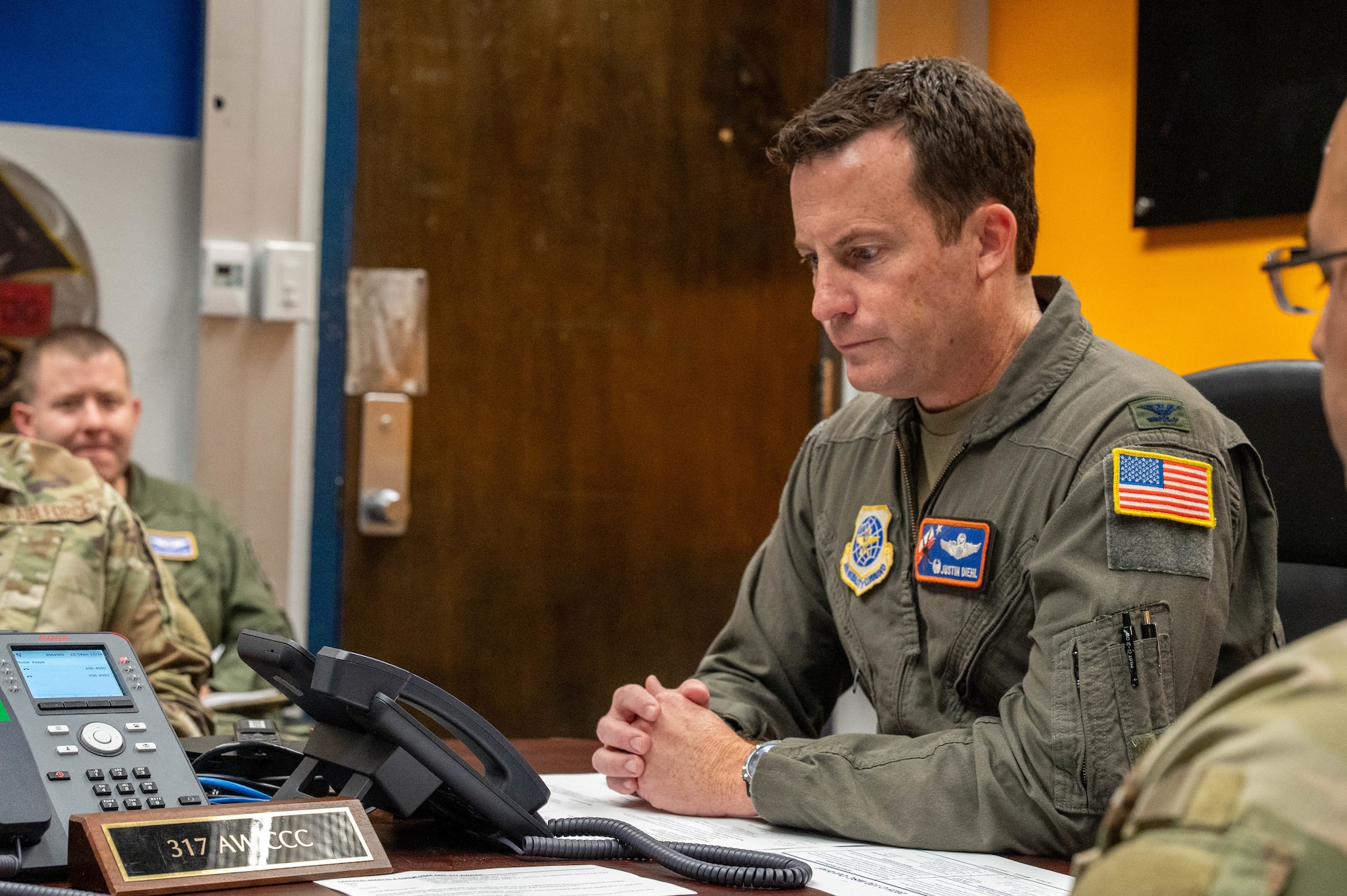 Secretary of the Air Force Troy Meink speaks over the phone with U.S. Air Force Col. Justin Diehl, 317th Airlift Wing commander, at Dyess Air Force Base, Texas, Dec. 24, 2025. During the holiday morale call, Meink thanked the 317th Airlift Wing for their dedicated service over the past year. (U.S. Air Force photo by Airman William Neal)