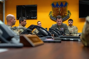 Secretary of the Air Force Troy Meink speaks over the phone with U.S. Air Force Col. Justin Diehl, 317th Airlift Wing commander, at Dyess Air Force Base, Texas, Dec. 24, 2025. During the call, Meink shared his appreciation for their service and wished the Airmen a happy holiday season. (U.S. Air Force photo by Airman William Neal)