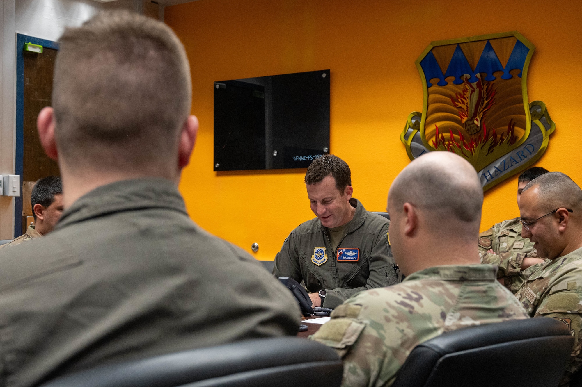 U.S. Air Force Col. Justin Diehl, 317th Airlift Wing commander, speaks with Secretary of the Air Force Troy Meink over the phone during a holiday morale call at Dyess Air Force Base, Texas, Dec. 24, 2025. Meink recognized the 317th AW for their exceptional service and recent accomplishments, including achieving a “highly effective” grade on their Foundational Readiness Inspection. (U.S. Air Force photo by Airman William Neal)