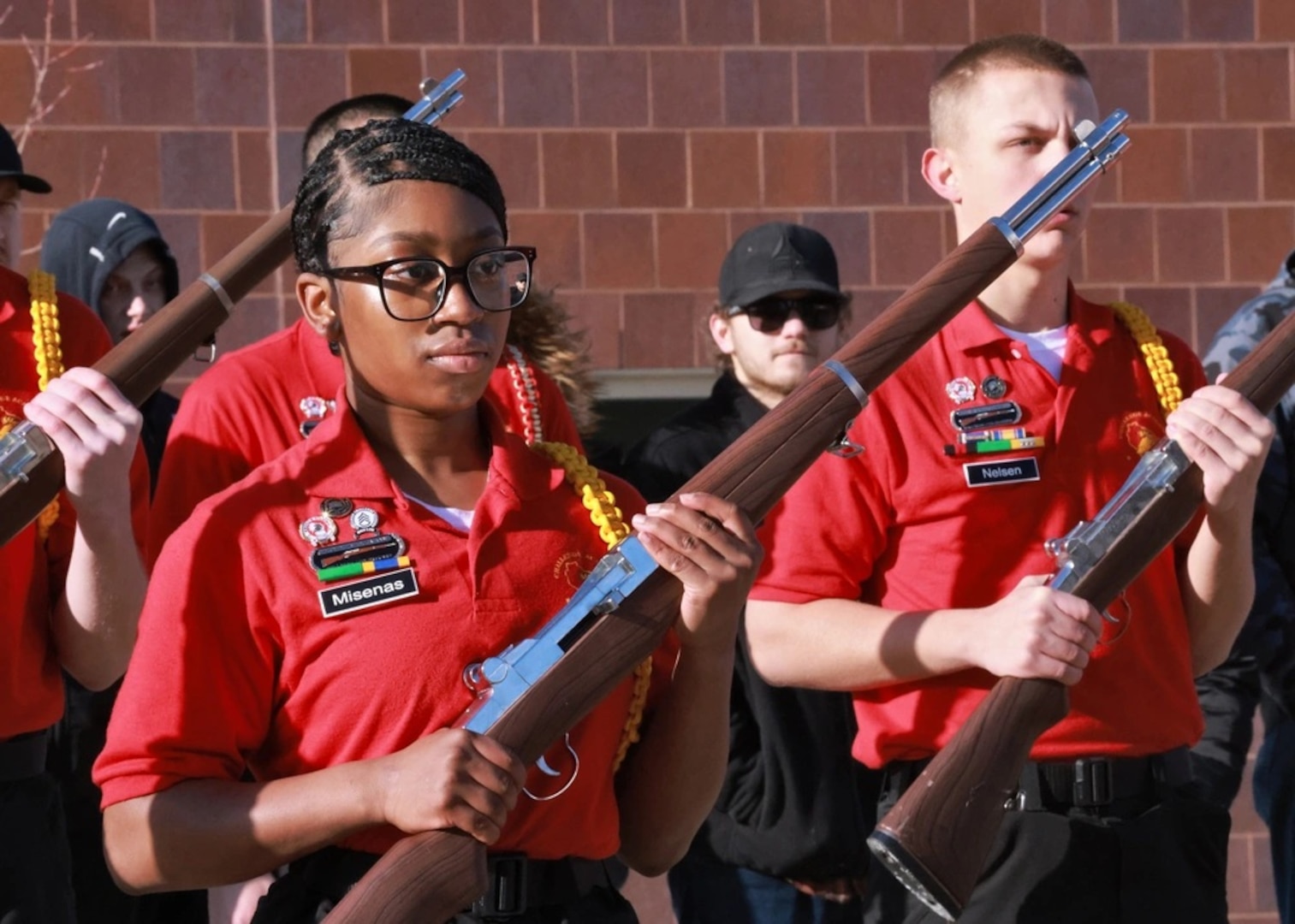 Cadets conduct a drill team demonstration for their graduating class.