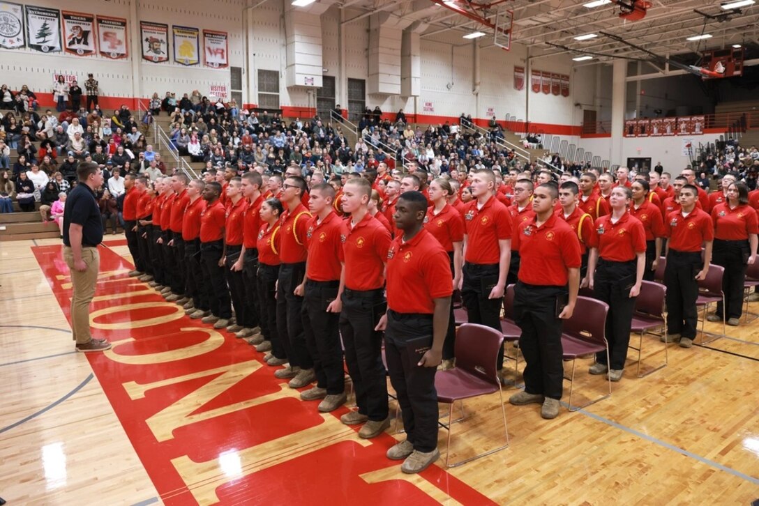 A group of cadets standing at attention on a drill floor