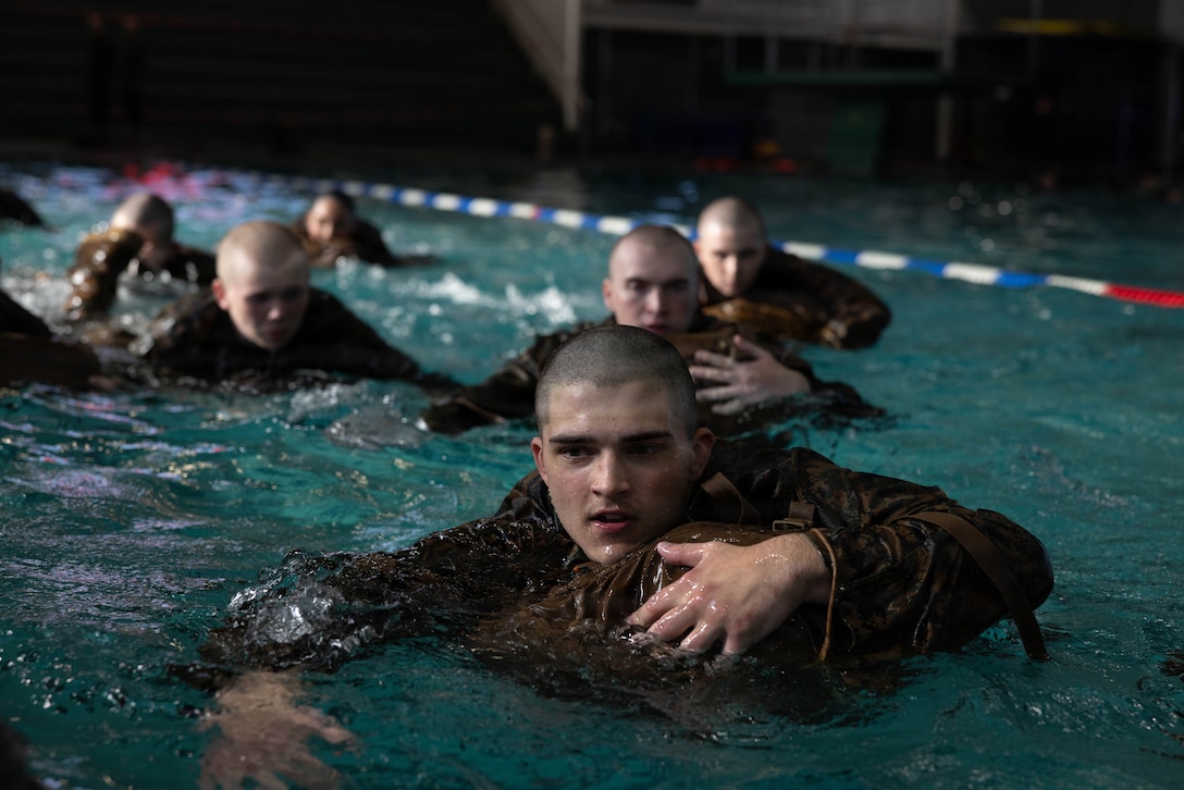 Recruits with Alpha Company, 1st Recruit Training Battalion, complete their Improved Loadbearing Equipment (IBLE) pack assisted swim during swim week on Marine Corps Recruit Depot Parris Island, S.C., Dec. 15, 2025. Recruits must demonstrate their proficiency in the water while maintaining positive control of their IBLE. (U.S. Marine Corps photo by Cpl. Kenneth Johnson)