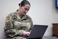 A woman soldier using a laptop.