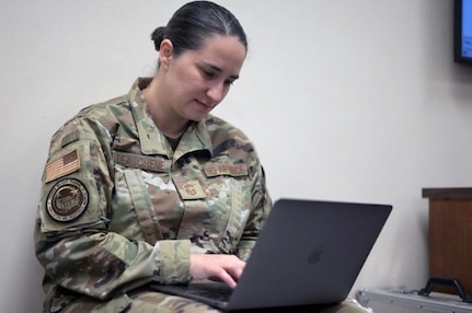A woman soldier using a laptop.