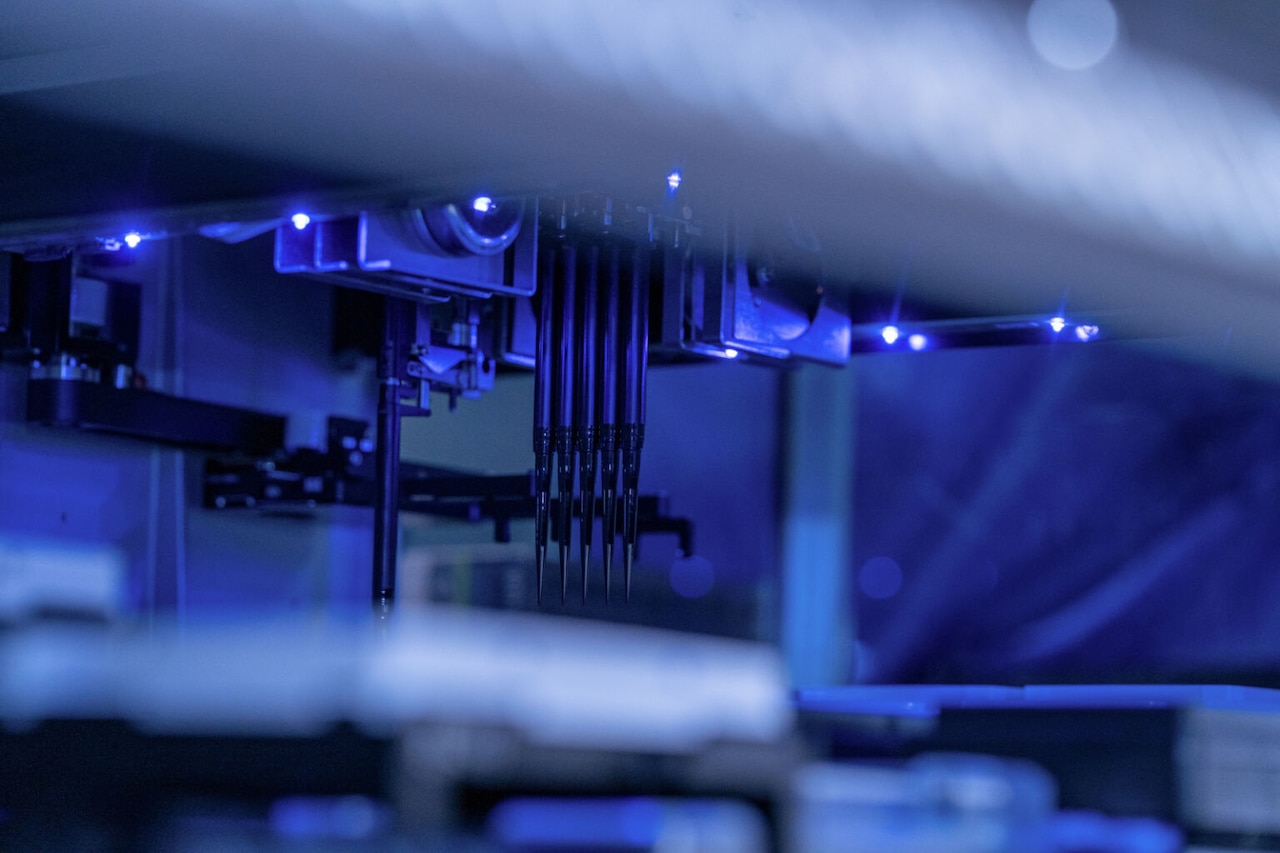 A machine takes DNA samples from small containers.