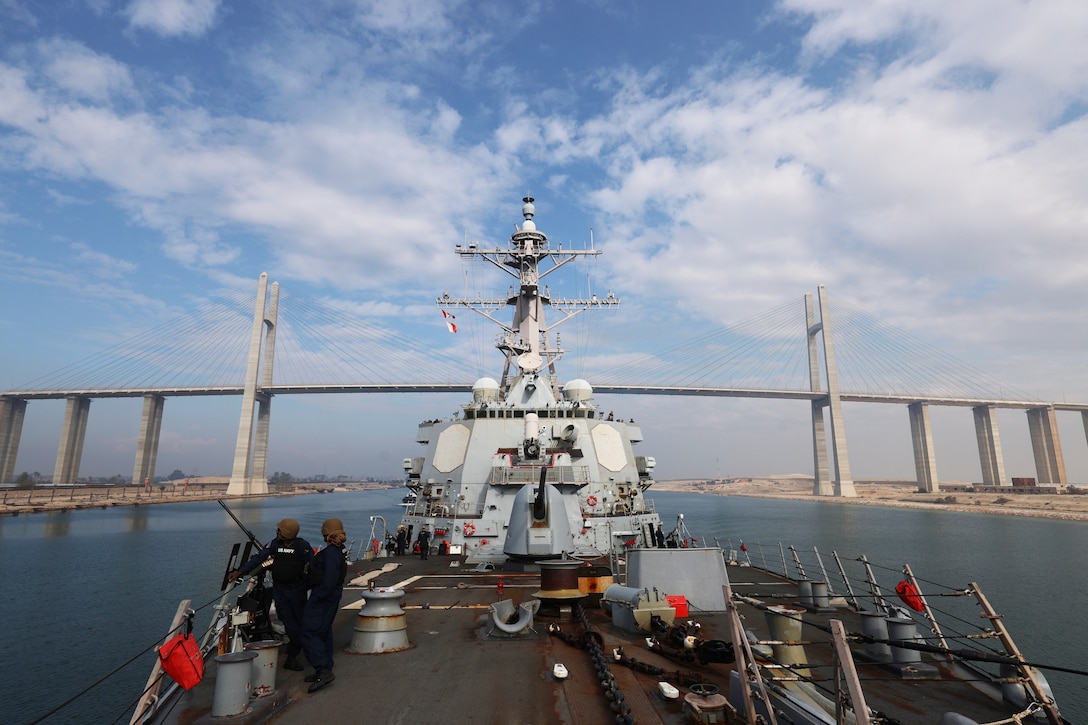 SUEZ CANAL (Dec. 15, 2025) The U.S. Navy Arleigh Burke-class guided-missile destroyer USS McFaul (DDG 74) passes under the Mubarak Peace Bridge while transiting the Suez Canal. McFaul is deployed to the U.S. 5th Fleet area of operations to support maritime security and stability in the U.S. Central Command area of responsibility. (U.S. Navy photo by Mass communication specialist 2nd Class Gabriel Fields)