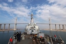 SUEZ CANAL (Dec. 15, 2025) The U.S. Navy Arleigh Burke-class guided-missile destroyer USS McFaul (DDG 74) passes under the Mubarak Peace Bridge while transiting the Suez Canal. McFaul is deployed to the U.S. 5th Fleet area of operations to support maritime security and stability in the U.S. Central Command area of responsibility. (U.S. Navy photo by Mass communication specialist 2nd Class Gabriel Fields)