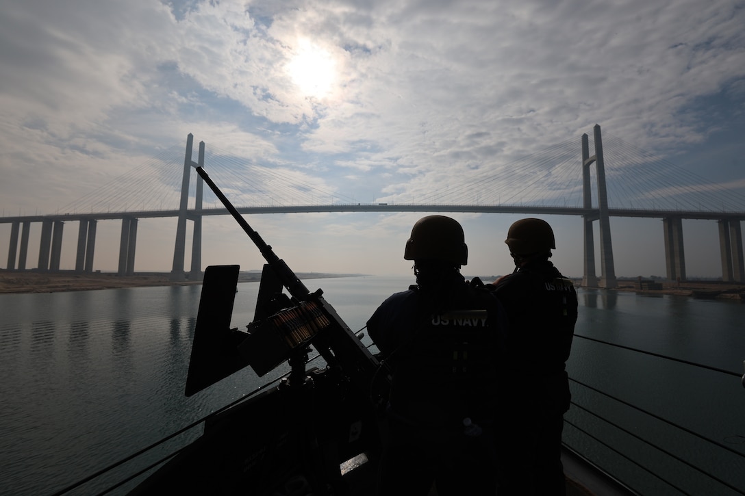SUEZ CANAL (Dec. 15, 2025) U.S. Navy Sonar Technician (Surface) Specialist 3rd Class Alexander Neira and Fire Controlman (Aegis) 3rd Class Jamia Blair stand watch on the bow of the Arleigh Burke-class guided-missile destroyer USS McFaul (DDG 74) while transiting the Suez Canal. McFaul is deployed to the U.S. 5th Fleet area of operations to support maritime security and stability in the U.S. Central Command area of responsibility. (U.S. Navy photo by Mass Communication Specialist 2nd Class Gabriel Fields)