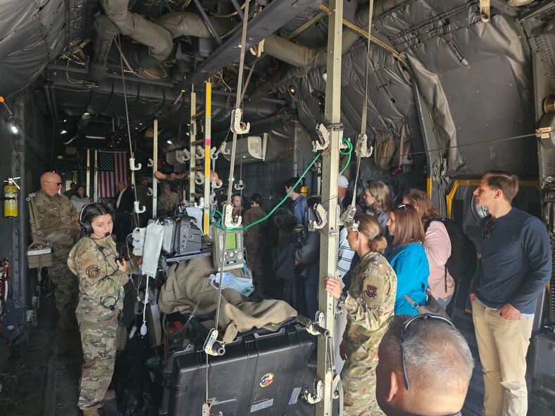 Personnel from the 59th Medical Wing and civilian observers examine in-flight medical equipment aboard a military aircraft during a demonstration at Joint Base San Antonio–Lackland, Texas, on Jan. 6, 2026.