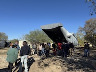 Visitors enter the rear cargo bay of a simulated military transport aircraft during a public engagement event at Joint Base San Antonio–Lackland, Texas, on Jan. 6, 2026.