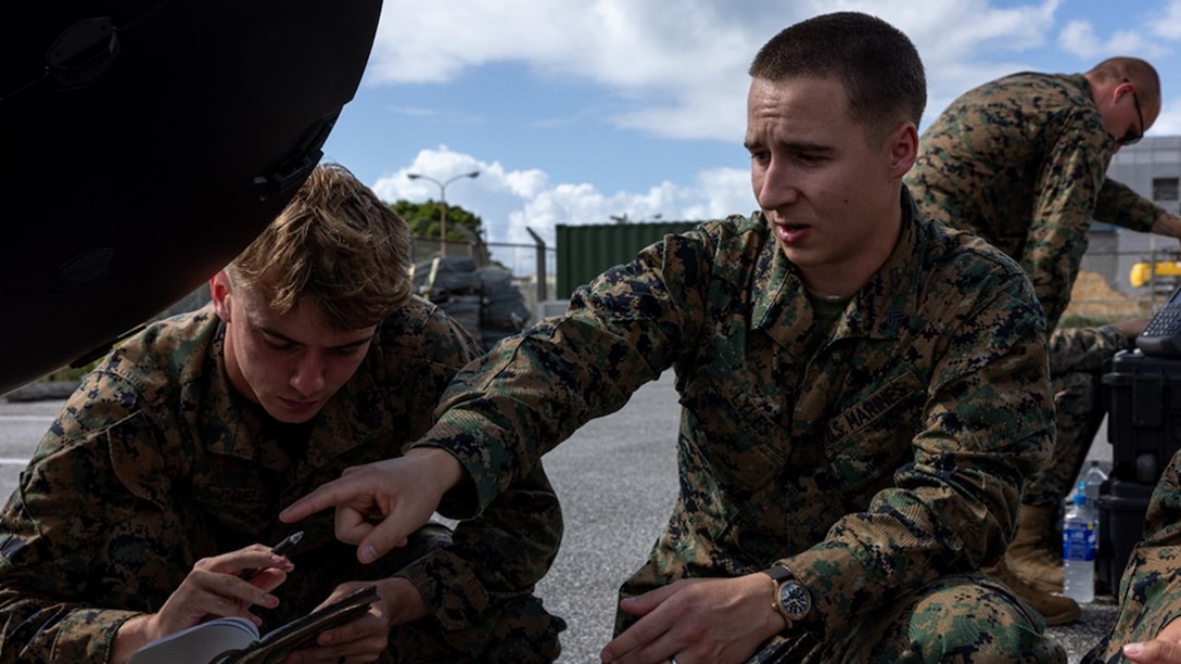 12th MLR’s Sgt Charles Daniels (PMOS 2651, home state Virginia), receives instruction from Sgt Trevor Lyles (PMOS 2631, home state Alabama), on the Electromagnetic Reconnaissance System (ERS) antenna.