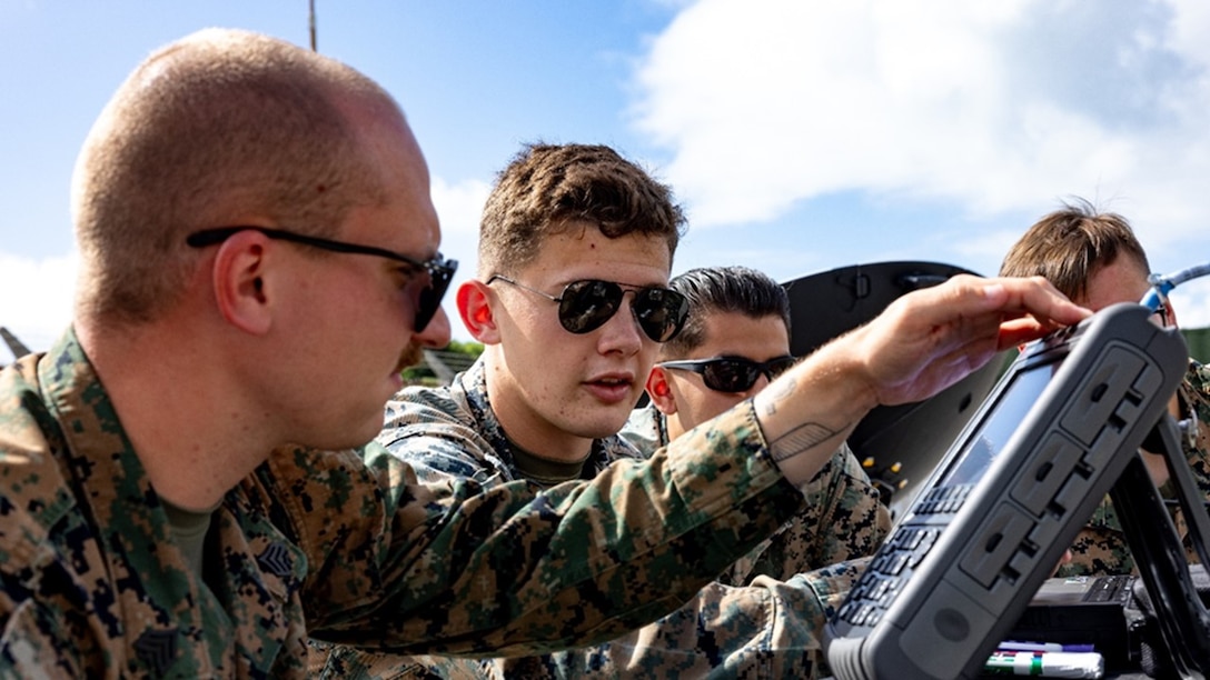 From left, Sgt Jonathon Sloan (PMOS 2651, home state Kentucky), Cpl Eugene Sanchez (PMOS 2641, home state Pennsylvania), Cpl Gustavo Ruiz (PMOS 2651, home state California), and LCpl Garrett Fife (PMOS 2621, home state New York), work through a spectrum analyzer practical application during New Equipment Training for the Electromagnetic Reconnaissance System (ERS).