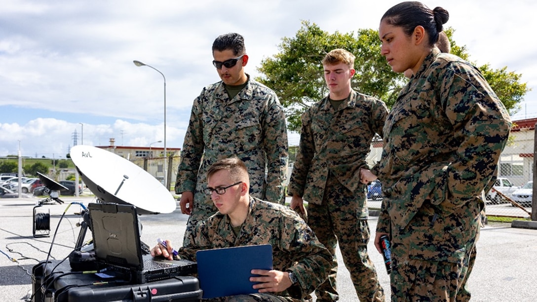 Cpl Ruiz Gustavo (PMOS 2651, home state California), Sgt Charles Daniels (PMOS 2651, home state Virginia), Sgt Jonathan Sloan (PMOS 2651, home state Kentucky), and Sgt Loraine Espinoza (PMOS 2651, home state California), assist and look on as LCpl Garrett Fife (PMOS 2621, home state New York) works through a hands-on practical application on antenna control during New Equipment Training for the Electromagnetic Reconnaissance System (ERS).