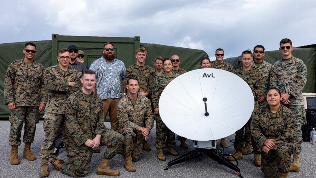 Marines and contractors from the program office, Training Command formal school, MEF Information Group, and 12th Marine Littoral Regiment pause for a group photo during New Equipment Training for the Electromagnetic Reconnaissance System (ERS).

Front row (kneeling): From left to right, LCpl Chad Austin (PMOS 2631, home state Virgina); GySgt Coleman Tull (PMOS 2629, home state Texas); Sgt Loraine Espinoza (PMOS 2651, home state California)

Back row (standing): From left to right, CWO5 Alex Cruz (PMOS 2602, home state Florida); LCpl Garrett Fife (PMOS 2621, home state New York); Mr. Mike Dabill (NIWC-Pacific contractor); Mr. Jeffrey Sillsbe (PM ICO contractor); Mr. Corey Webb (TRNG CMD contractor); Sgt Charles Daniels (PMOS 2651, home state Virgina); CWO2 Michael Ham (PMOS 2602, home state North Carolina); Capt Liliana Bautista (PMOS 1702, home state Illinois); Sgt Jonathan Sloan (PMOS 2651, home state Kentucky); Maj Juliann Hitt (PMOS 1706, home state California); Maj Robert Costello (PMOS 1706, home state New York); Sgt Trevor Lyles (PMOS 2631, home state Alabama); Sgt Gustavo Ruiz (PMOS 2651, home state California); Cpl Eugene Sanchez (PMOS 2641, home state Pennsylvania).