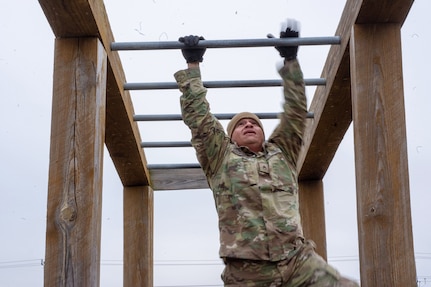 A Soldier assigned to the 2-382nd Logistic Support Battalion, 85th U.S. Army Reserve Support Command, navigates an obstacle course during the Mustangs Challenge readiness training conducted at Fort Hood, Texas, December 14, 2025.