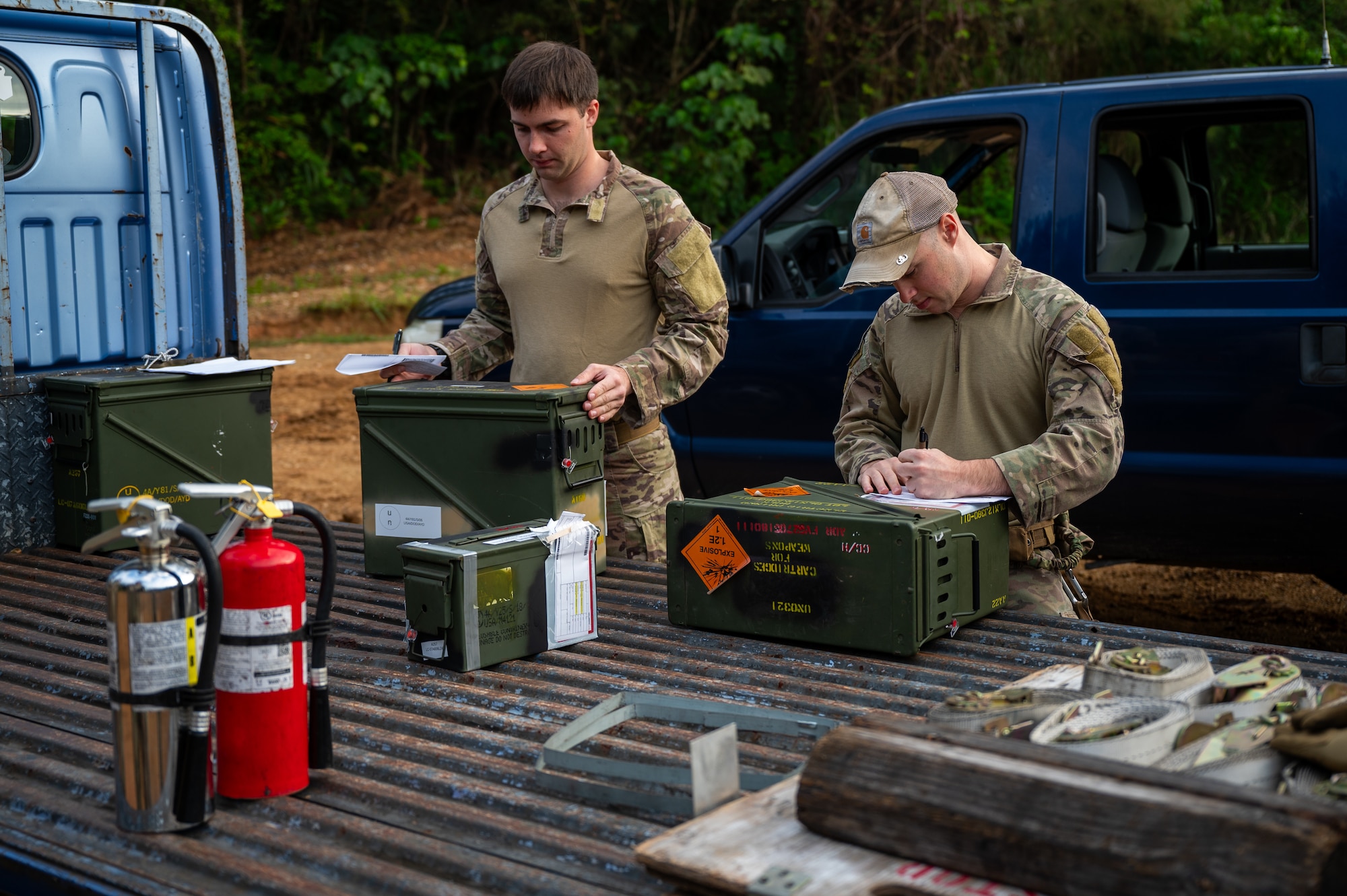 U.S. Air Force Staff Sgt. Alec Moore, left, 18th Civil Engineer Squadron explosive ordnance disposal team leader, and Staff Sgt. Giovanni Varano, 18th CES EOD team member prepare unusable Code H munitions during a scheduled disposal operation at Kadena Air Base, Japan, Dec. 18, 2025. By eliminating hazardous munitions, the team reduced risk to personnel, infrastructure and surrounding communities across the installation. (U.S. Air Force photo by Airman 1st Class Francisco Huerta)