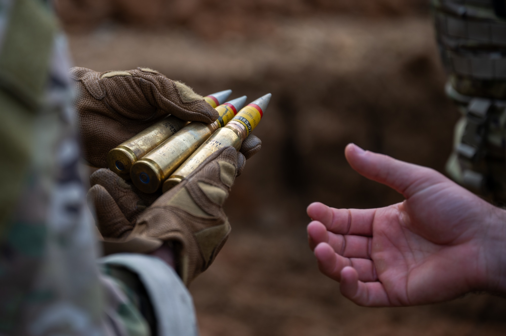 U.S. Air Force Airmen from the 18th Munitions Squadron inspect PGU-28 20mm high-explosive incendiary ammunition before disposal at Kadena Air Base, Japan, Dec. 18, 2025. The controlled detonation allows the 18th Wing to preserve resources while maintaining the highest safety standards. (U.S. Air Force photo by Airman 1st Class Francisco Huerta)