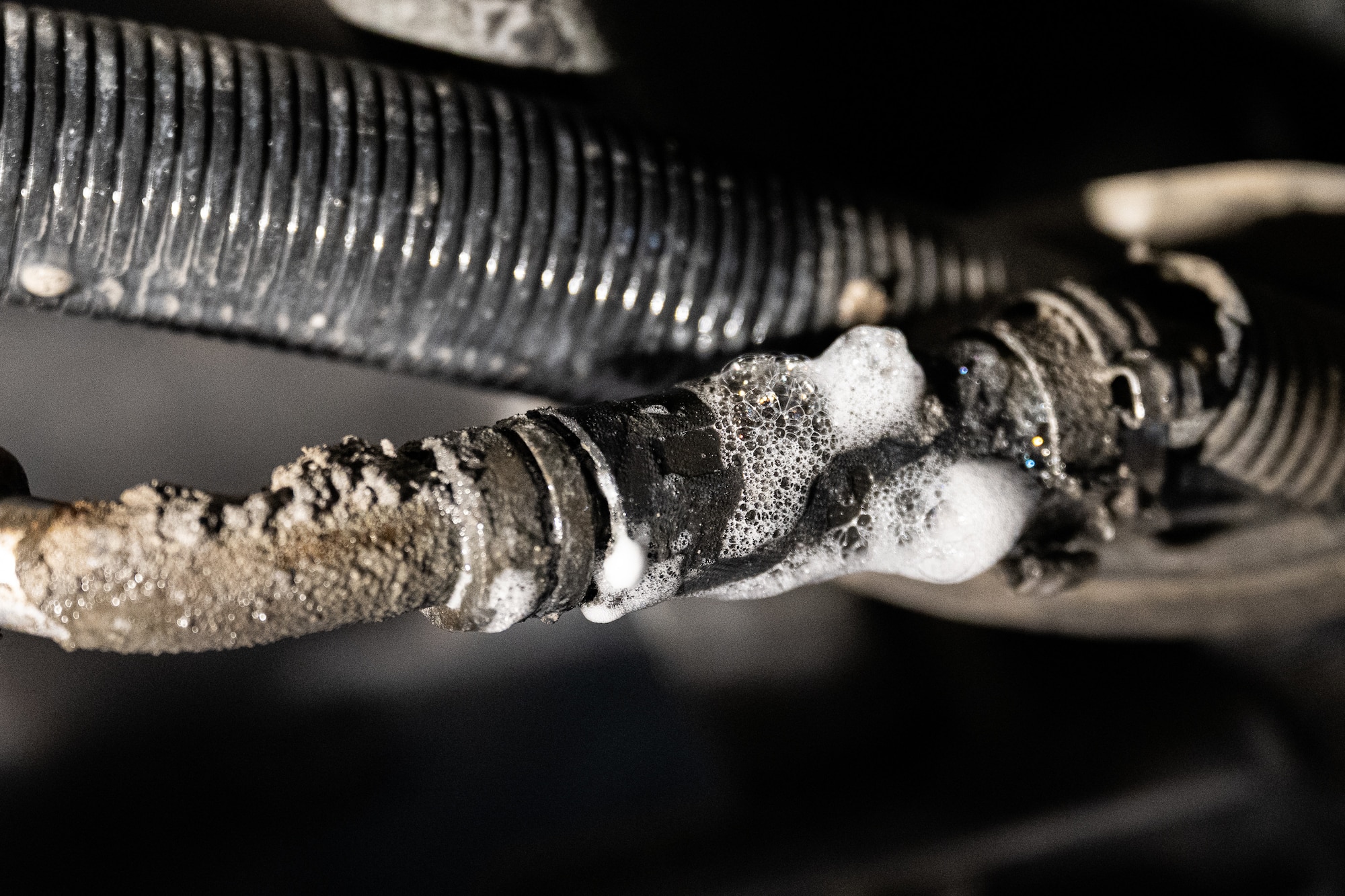 Soapy bubbles foaming around a component.