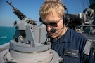 U.S. Navy Quartermaster Seaman River Brown looks through a navigational compass on the bridge wing of the Arleigh Burke-class guided-missile destroyer USS Mitscher (DDG 57), Jan. 5, 2025. Mitscher is deployed to the U.S. 5th Fleet area of operations to support maritime security and stability in the U.S. Central Command area of responsibility.