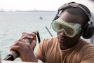 U.S. Navy Cryptologic Technician (Collection) Seaman Chaplain Adusei uses a needle gun for deck preservation on the foc’sle of the Arleigh Burke-class guided-missile destroyer USS Mitscher (DDG 57), Jan. 5, 2025. Mitscher is deployed to the U.S. 5th Fleet area of operations to support maritime security and stability in the U.S. Central Command area of responsibility.
