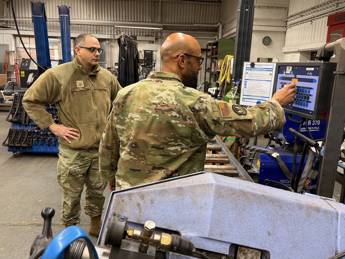 U.S. Air Force Master Sgt. William Parisse, 435th AGOW Safety superintendent, performs a safety inspection on an emergency shut-off switch with Master Sgt. Michael Moore, 435th Construction and Training Squadron Transportation Flight superintendent, at Ramstein Air Base, Germany. Parisse is one half of the 435 AGOW Safety Office that was awarded 2025 United States Air Forces in Europe-United States Air Forces Africa Chief of Safety Outstanding Achievement Award Category IV, an award recognizing the most effective safety program. (Courtesy photo)