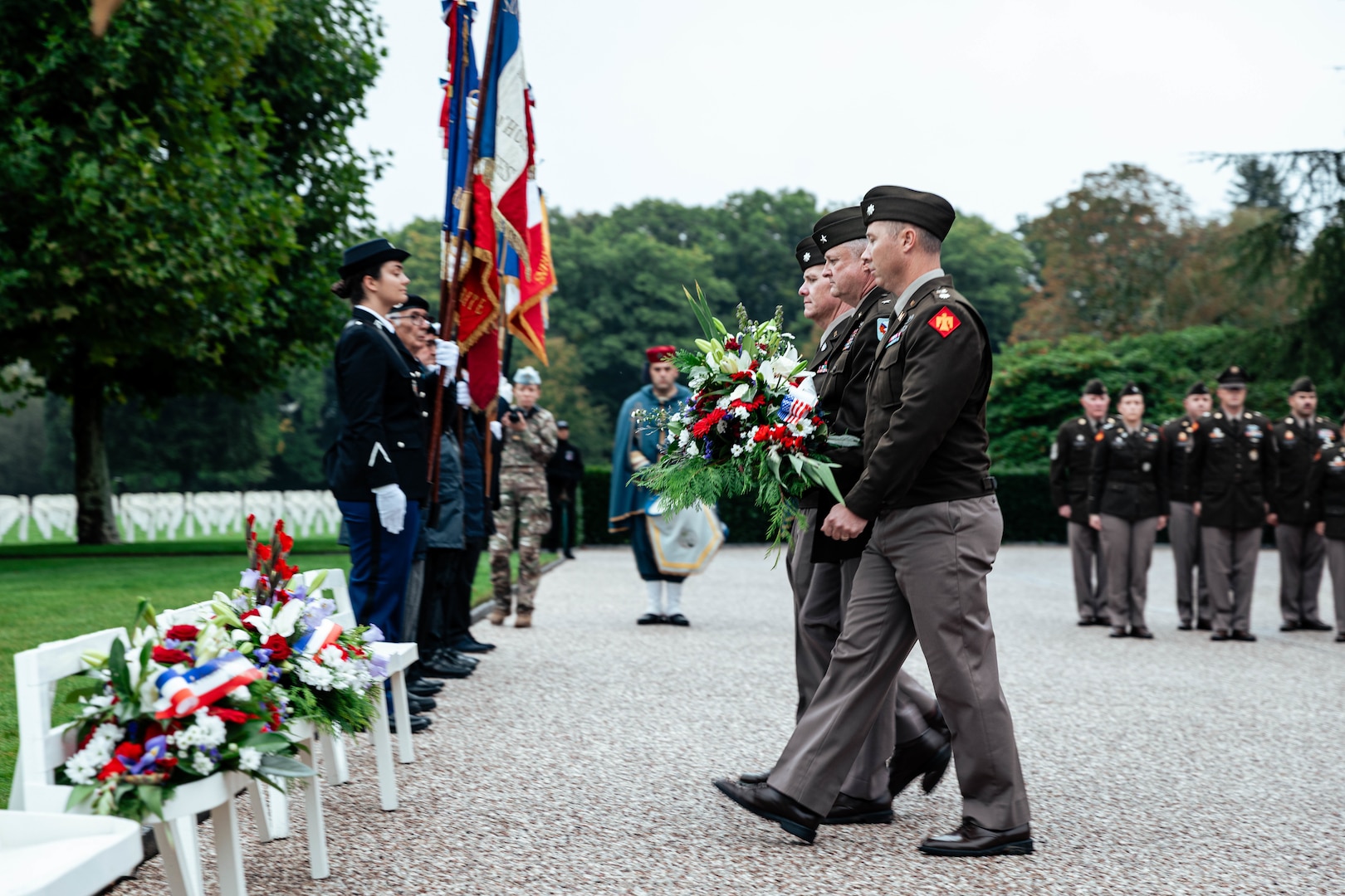 (From right) Lt. Col. Neal Harvey, Brig. Gen. Brad Carter, assistant adjutant general-Army for Oklahoma, and Lt. Col. Caleb Emde prepare to lay a wreath during a ceremony honoring the 45th Infantry Division Soldiers laid to rest at Epinal American Cemetery and Memorial in Epinal, France, Sept. 24, 2025.  The delegation of Oklahoma National Guard members toured key locations from the 45th Infantry Division’s campaign in northeastern France against German forces during World War II. (U.S. Army photo by Staff Sgt. John Stoner)