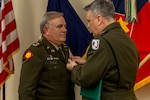 Col. Kevin Roland receives the Legion of Merit from Maj. Gen. Thomas H. Mancino, adjutant general for Oklahoma, during his retirement ceremony at the Oklahoma City Military Complex in Oklahoma City, Oct. 30, 2025. Roland served 34 years in the military, starting in the Marine Corps before joining the Oklahoma Army National Guard, where he served in numerous impactful roles. Though retired from military service, Roland will continue to serve in a civilian role as the State Youth Programs Director, where he will oversee Thunderbird Challenge Program, Sooner Job Challenge and STARBASE Oklahoma. (Oklahoma National Guard Photo by Sgt. Haden Tolbert)
