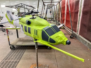 A HH-60W Jolly Green II model is positioned on a stand, ready to be painted at Moody Air Force Base, Georgia, July 17, 2025. Airmen from the 23d Maintenance Squadron repaired and restored the model for display at the Moody AFB’s gate. (U.S. Air Force photo by Tech. Sgt. Christopher Buentello)