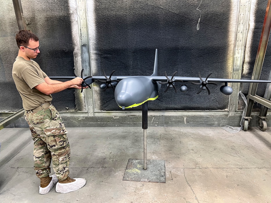 U.S. Air Force Senior Airman Memphis Waller, 23d Maintenance Squadron aircraft structural maintenance specialist, attaches a propeller to an HC-130J Combat King II model at Moody Air Force Base, Georgia, Oct. 28, 2025. Airmen carefully repaired and restored the static display models to preserve Moody’s heritage. (U.S. Air Force photo by Tech. Sgt. Christopher Buentello)