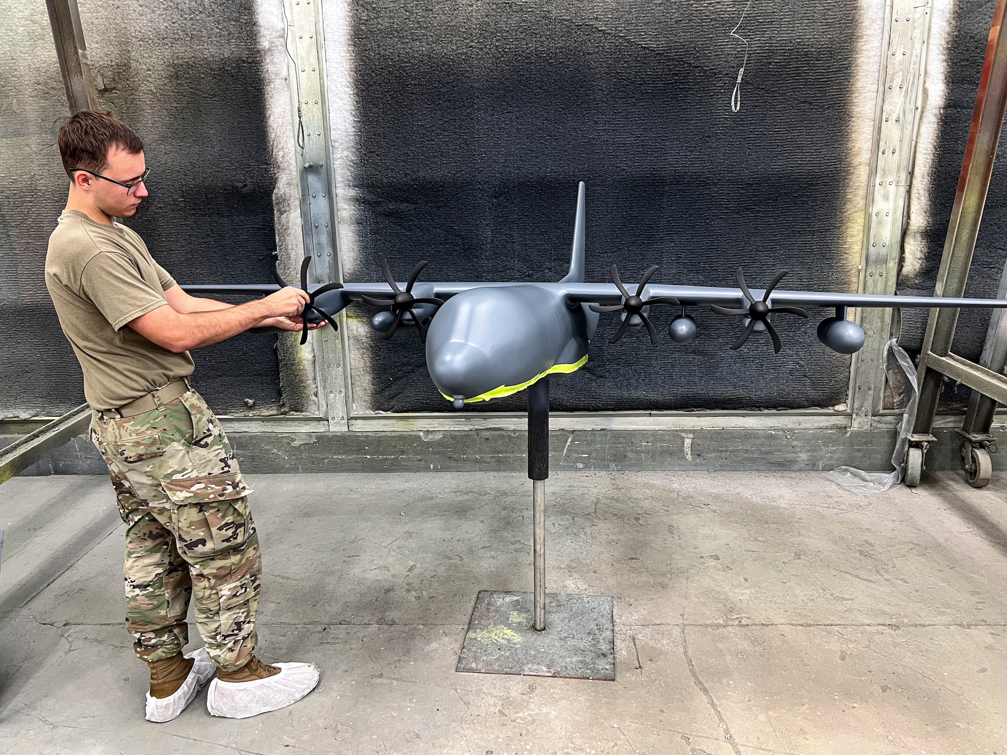 U.S. Air Force Senior Airman Memphis Waller, 23d Maintenance Squadron aircraft structural maintenance specialist, attaches a propeller to an HC-130J Combat King II model at Moody Air Force Base, Georgia, Oct. 28, 2025. Airmen carefully repaired and restored the static display models to preserve Moody’s heritage. (U.S. Air Force photo by Tech. Sgt. Christopher Buentello)