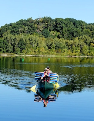 The U.S. Naval Research Laboratory (NRL) launched a groundbreaking remote sensing experiment, Coastal Hyperspectral Reflectance Object Material Analysis (CHROMA), Sept. 4-19, 2025, designed to accelerate the application of artificial intelligence (AI) in hyperspectral imaging and strengthen environmental intelligence and resource management capabilities across the Department of War and the wider scientific community. NRL’s CHROMA Project Lead Katarina Doctor, Ph.D., and Scott Ramsey, Head of the NRL Signature Technology Office deliver coated panels by boat for placement on the water.  The hands-on effort was critical for positioning targets for airborne and satellite data collection. (Photo by Cécile Darviot, DRDC)