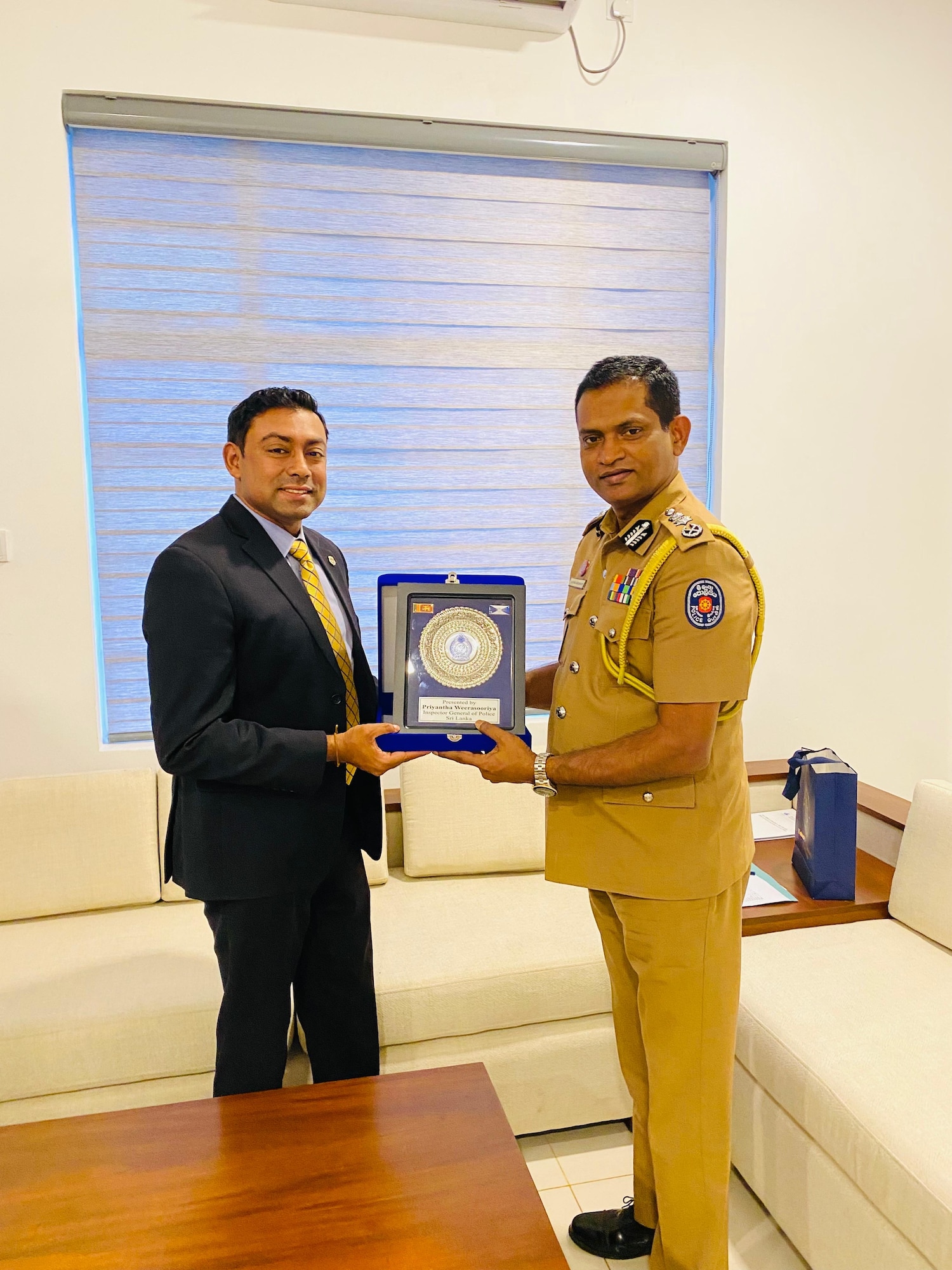 Special Agent Danitha Amarawardana, Air Force Office of Special Investigations 13th Field Investigations Squadron’s OL-B detachment, receives an award from a Sri Lankan police official during a meeting in Colombo, Sri Lanka.