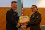 251216-N-JC800-1049 YORKTOWN, Virginia (Dec. 16, 2025) - Capt. James Corbett, commanding officer of Naval Medical Leader and Professional Development Command, presents a certificate of completion to U.S. Army Pfc. Rayohnalee Rodriguez during the graduation ceremony for the Tri-Service Optician School Class 25010, Dec. 16. (U.S. Navy photo by Mass Communication Specialist 1st Class Heath Zeigler/Released)