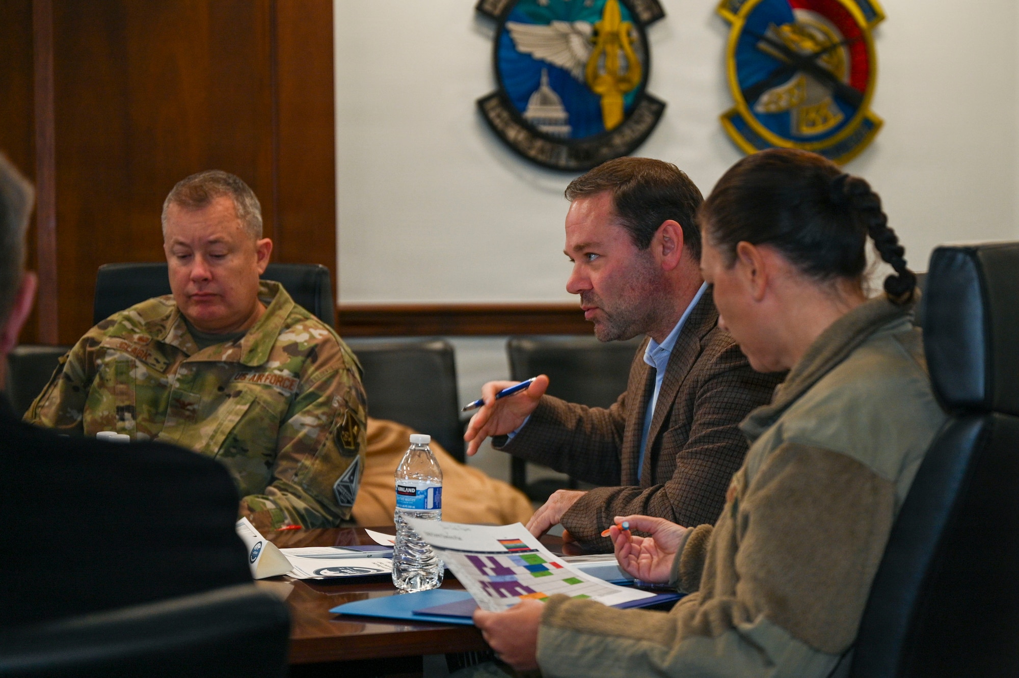 Adam Dontz, center, Deputy Assistant Secretary of War for Housing, meets with the U.S. Air Force’s 11th Wing and Joint Base Anacostia-Bolling leadership regarding the on-base dormitories at JBAB, Washington, D.C., Dec. 9, 2025. Leadership discussed JBAB dormitory conditions and plans to improve the living spaces for JBAB’s junior enlisted members.  (U.S. Air Force photo by Airman 1st Class Shanel Toussaint)