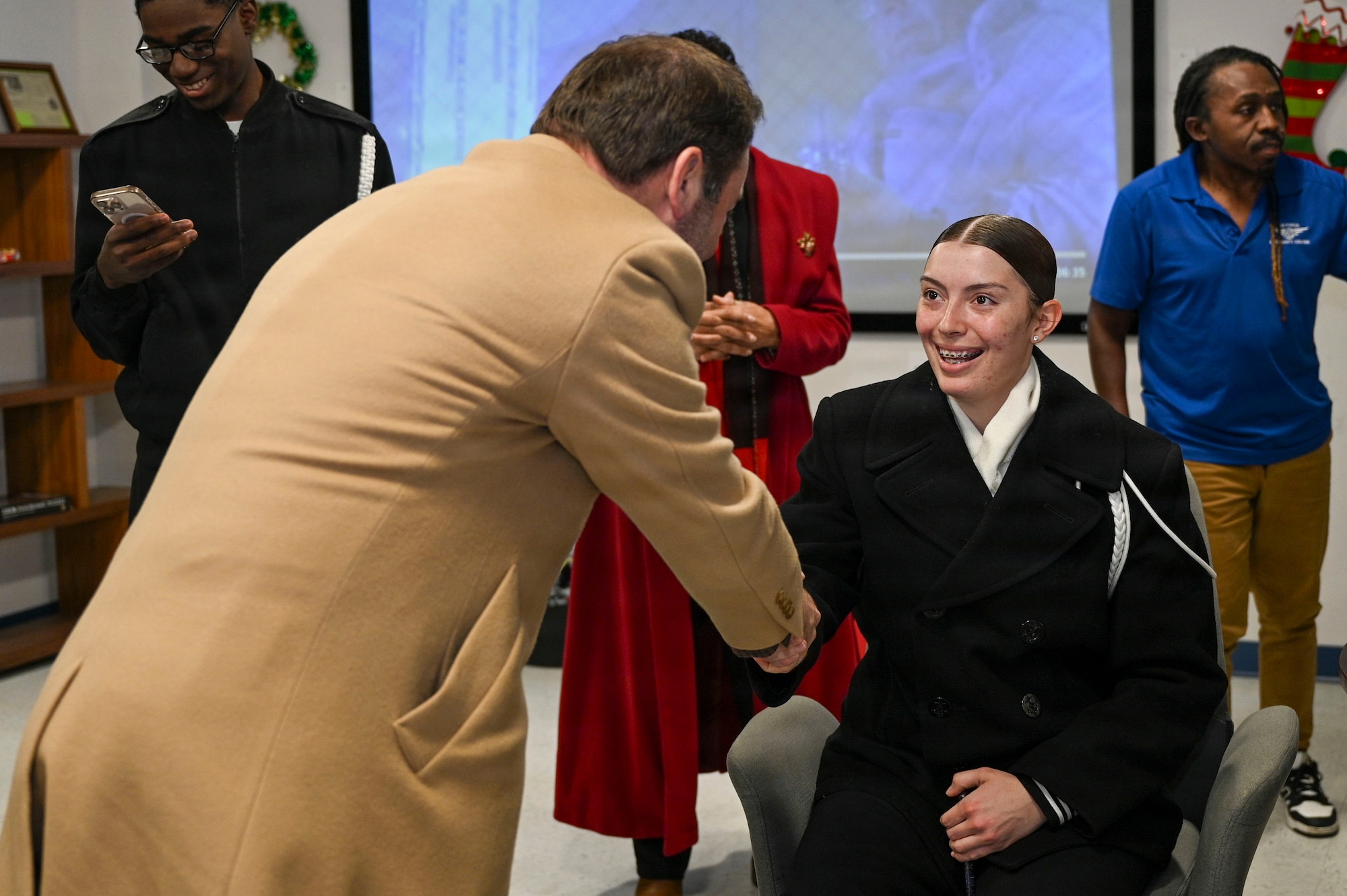 Adam Dontz, left, Deputy Assistant Secretary of War for Housing, greets U.S. Navy Seaman Payton Wilke, a member of the U.S. Navy Ceremonial Guard, during a dormitory tour on Joint Base Anacostia-Bolling, Washington, D.C., Dec. 9, 2025. The group met to tour existing housing facilities and discuss housing improvement projects for JBAB. (U.S. Air force photo by Airman 1st Class Shanel Toussaint)